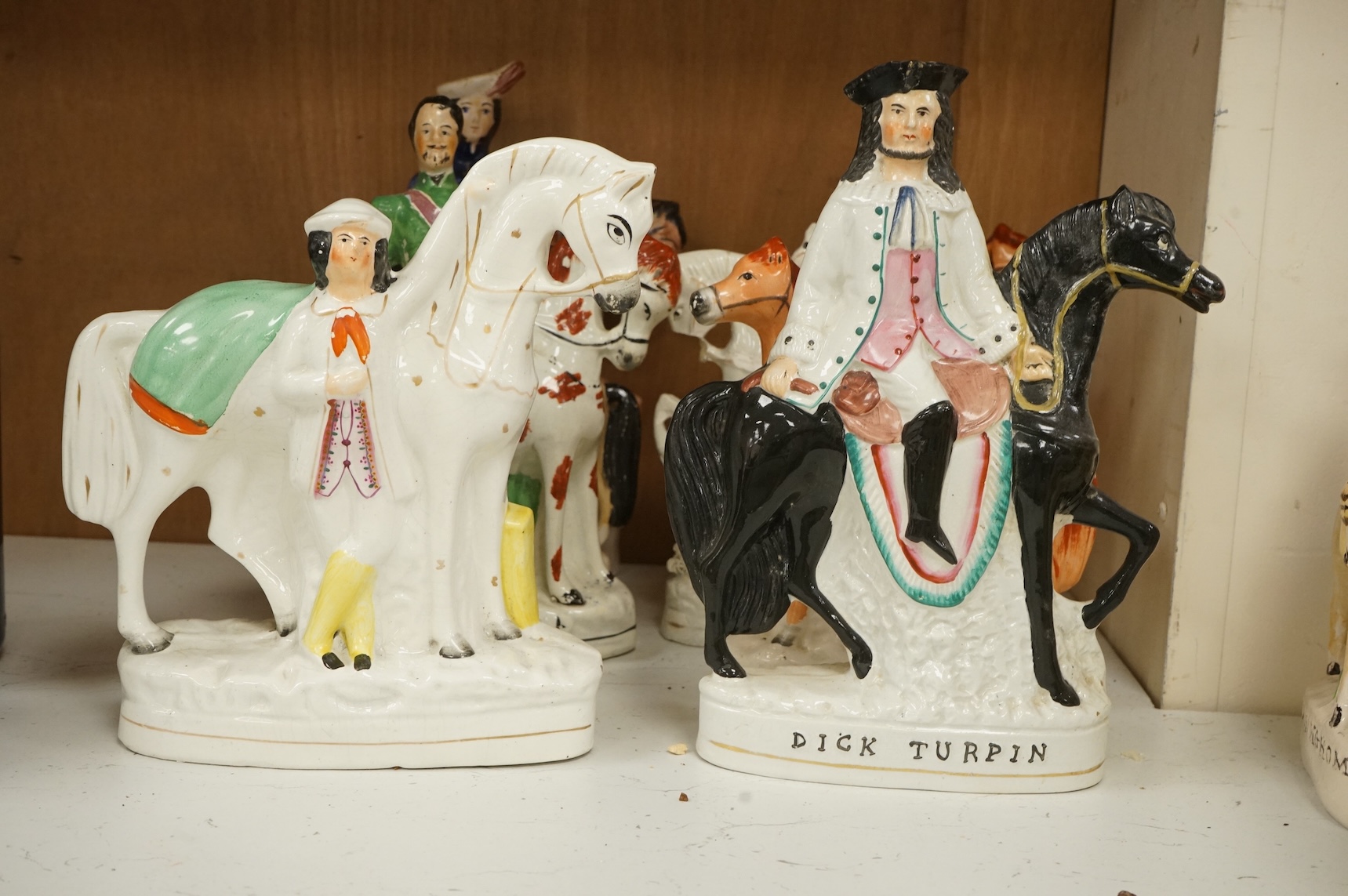Thirteen Staffordshire pottery equestrian figures to include Tom King, Dick Turpin and Sir Colin Campbell, largest 28cm high